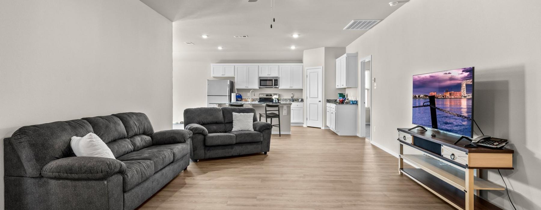 a living room with a tv and couches