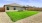 a house with a fence and grass