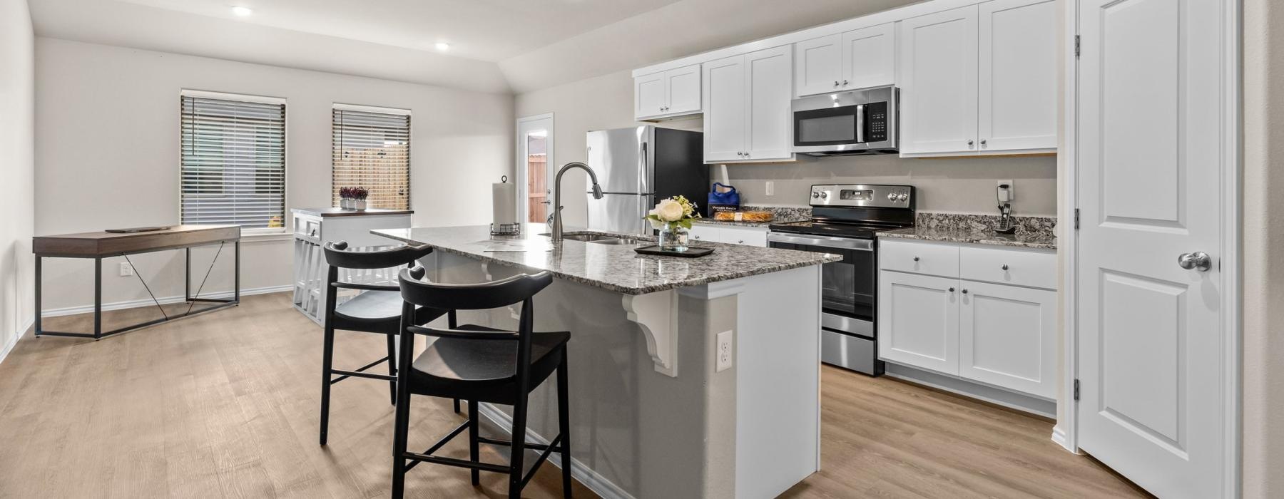 a kitchen with white cabinets